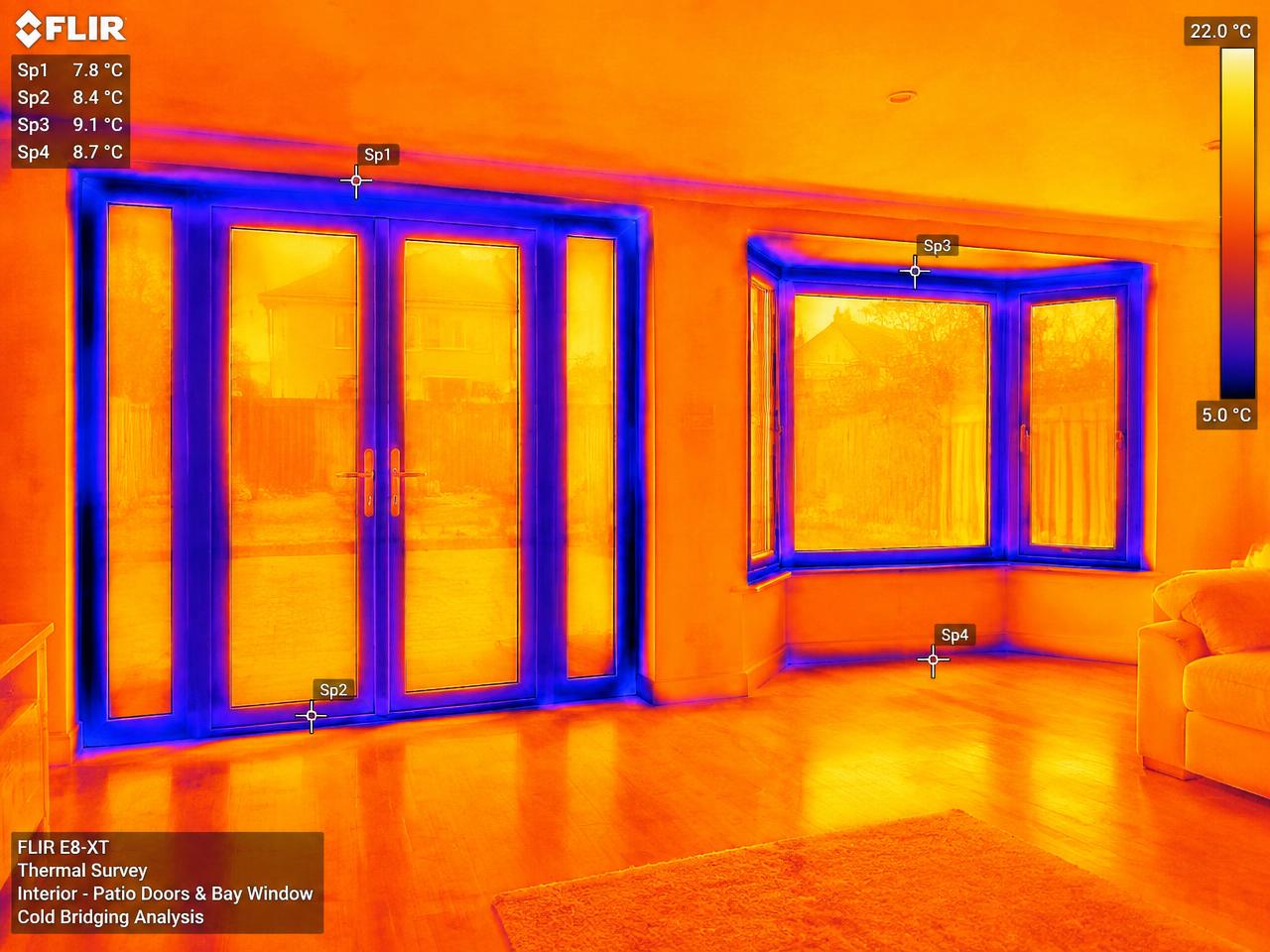 FLIR thermal scan of patio doors and a bay window showing cold bridging around the frames